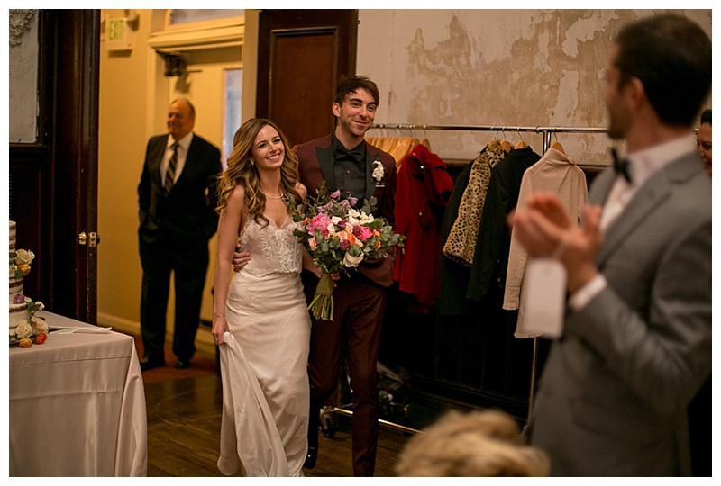 Alex Gaskarth giving a speech at his wedding reception, sharing heartfelt words with guests and his new wife.