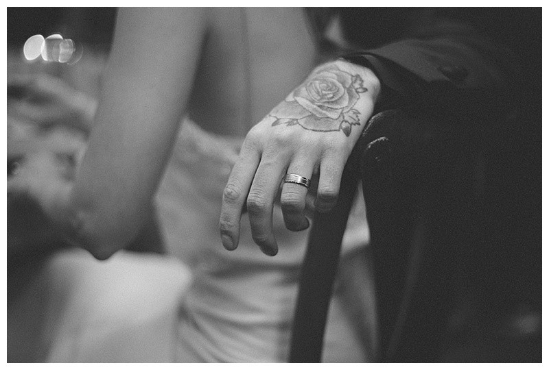 A close-up of the wedding cake cutting details, capturing the knife and the couple's hands during this traditional moment.