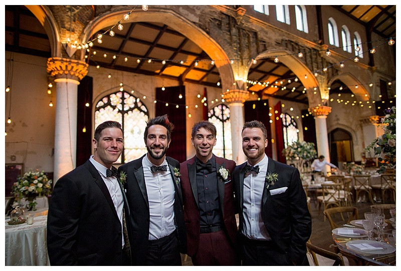 Lisa and Alex Gaskarth feeding each other cake, a playful and affectionate moment during their wedding reception.