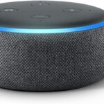 Close-up of an Amazon Echo Dot showing the blue light ring illuminated, indicating it is listening.