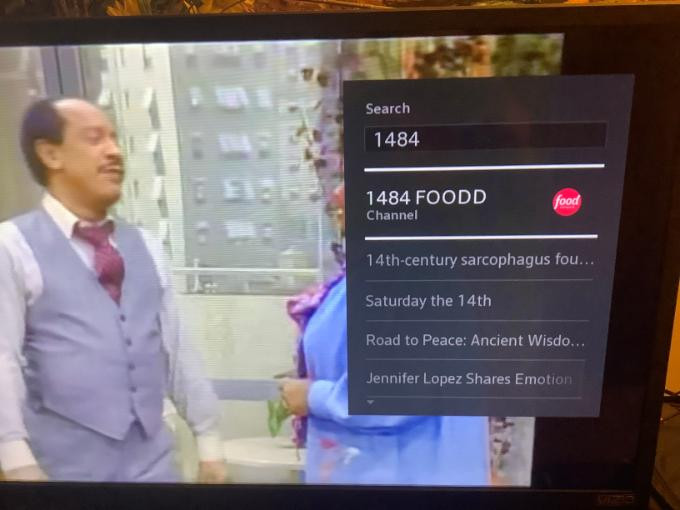 Xfinity TV screen showing channel info after Alexa command, illustrating the partial connection between Alexa and Xfinity for voice control.