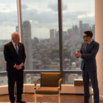 Alex Soros hosts Tim Walz at his New York City home, showcasing the Manhattan skyline.