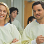 Alex and Izzie laughing together in Grey