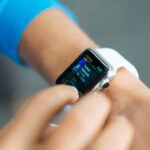 Woman checks smartwatch. Photo by Luke Chesser on Unsplash