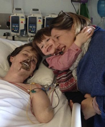 Alex Lewis in the hospital with his wife Lucy and son Sam