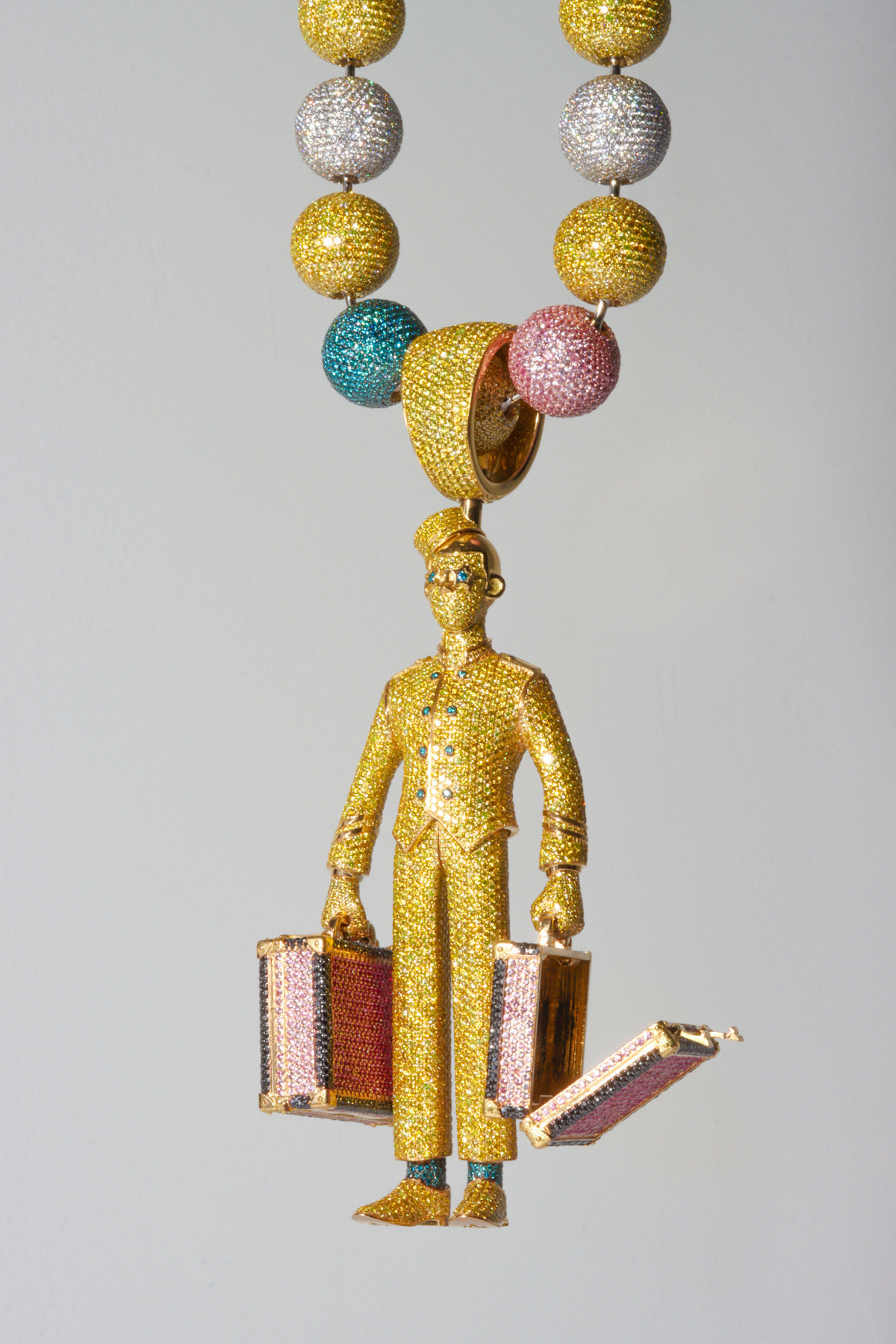 alt text: A gold bunny pendant with diamonds and sapphires by Alex Moss.